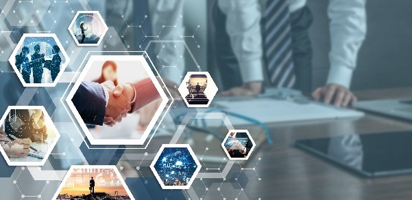  Business people gathered around a table. Over them are superimposed images representing business collaboration, such as people shaking hands, working on a document together, or having a discussion.